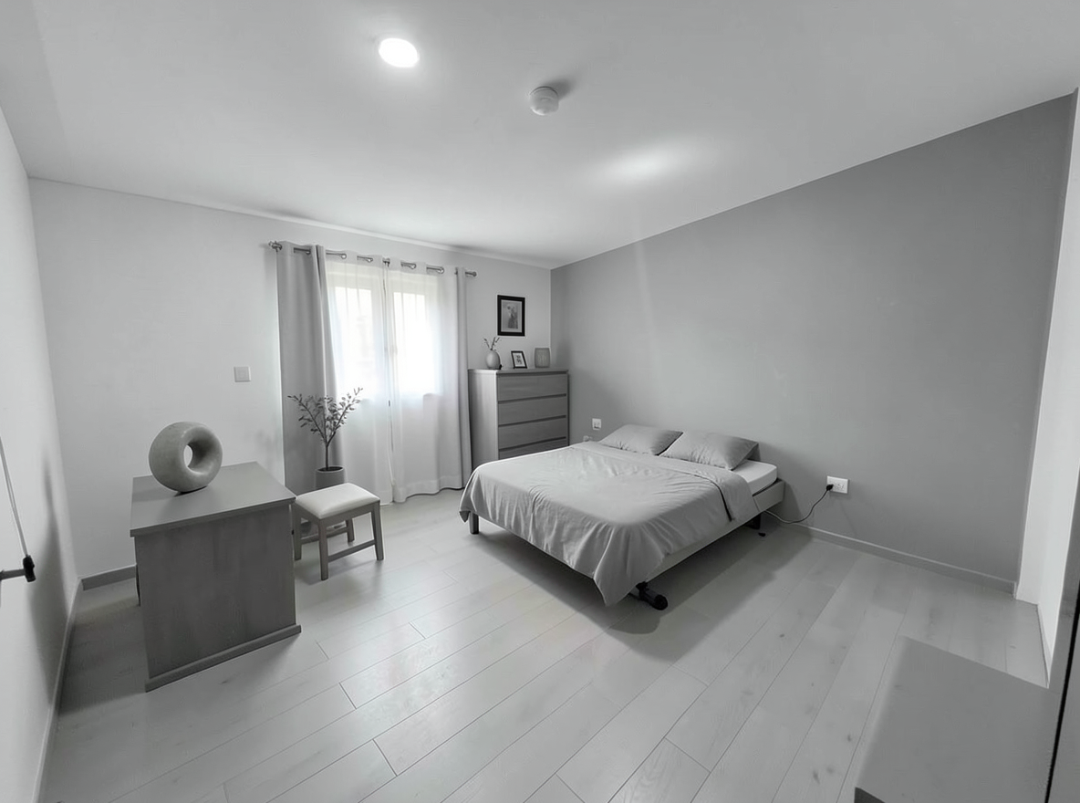 Main redesign studio: Redesign this room in a Minimalist interior style: an uncluttered space, a monochrome neutral palette, a few sculptural pieces, concealed storage, sof